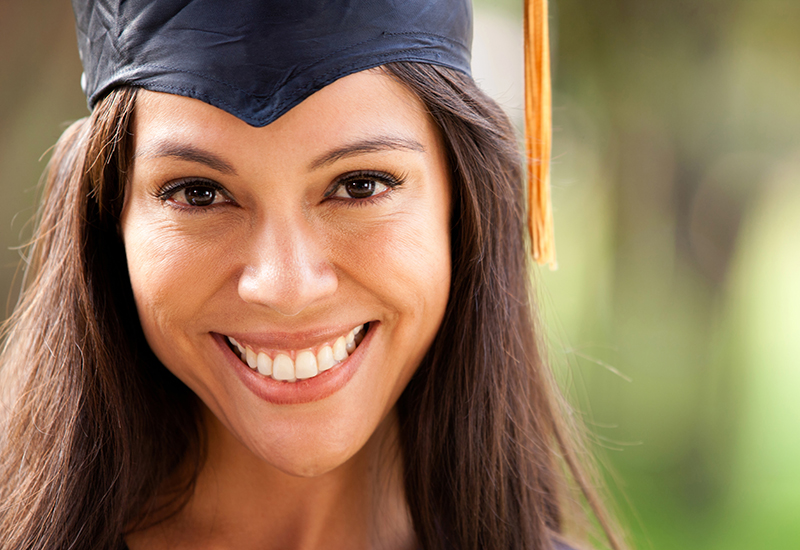Brunette woman in a graduation cap